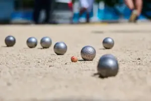 close-up-of-petanque-balls-and-jack-on-a-sandy-cou-2025-10-05-10-07-37-utc